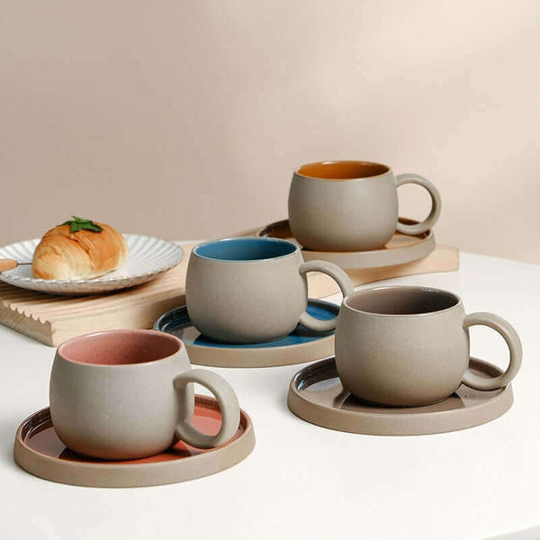 ZenCrafter Coffee Mug Set featuring four handcrafted ceramic mugs with matching saucers in various colors, perfect for coffee and tea lovers.